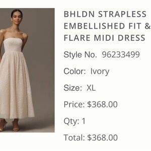 Ivory strapless BHLDN dress with flower embellishment.